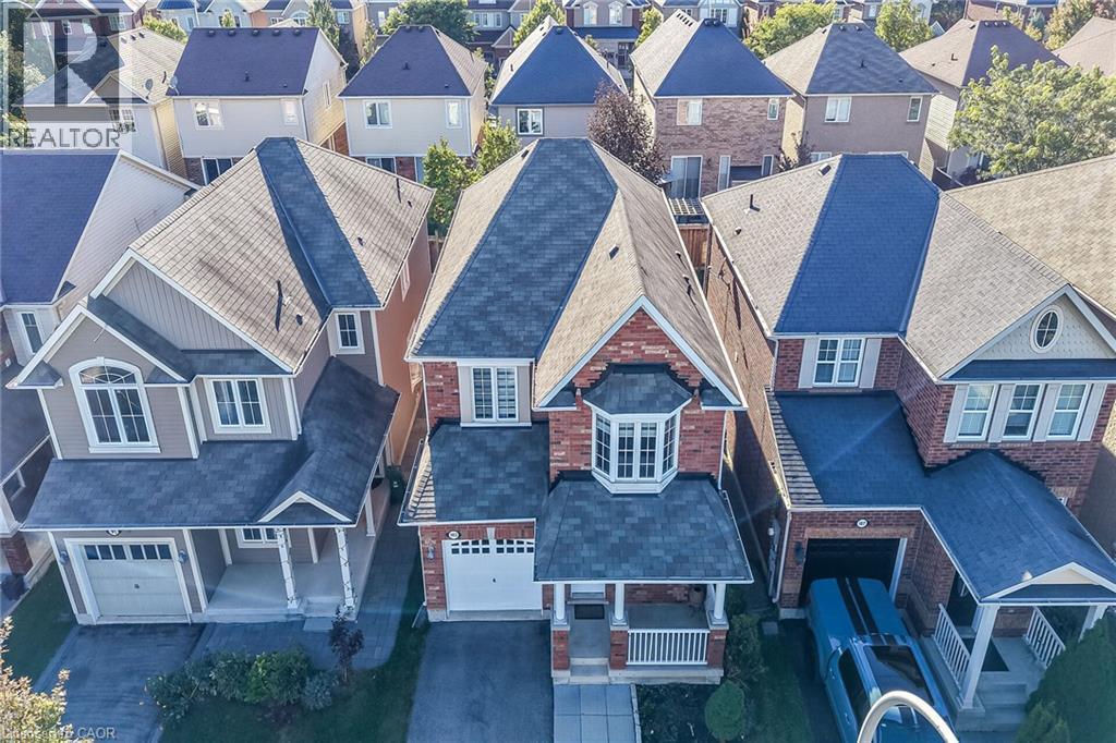 Brick and siding exterior with multiple pitched roofs - 103 Emick Drive, Ancaster, ON