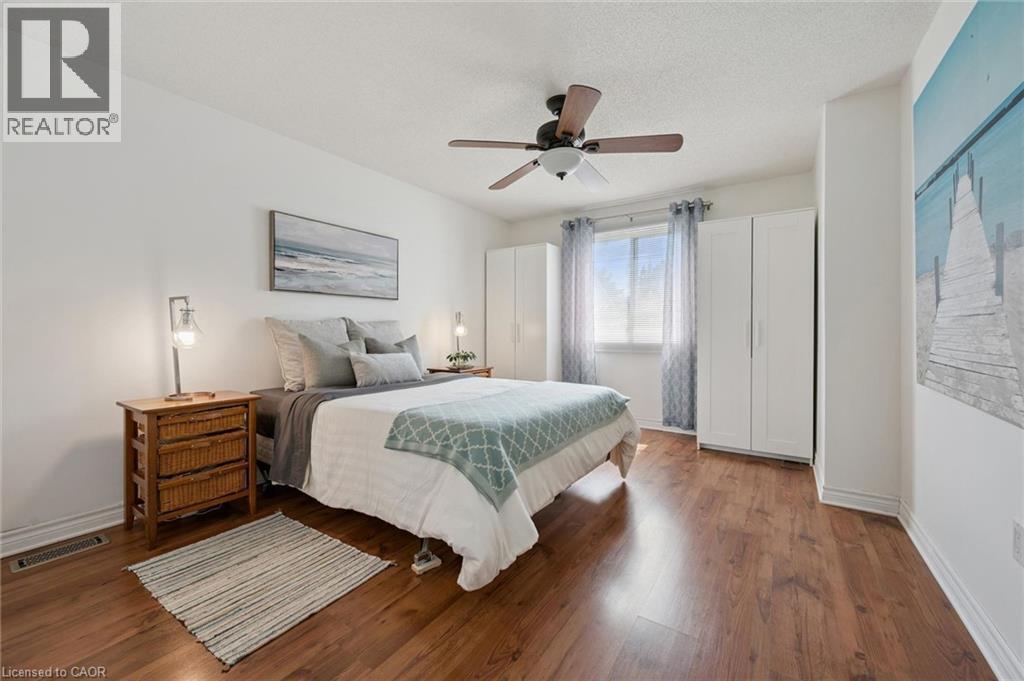 Wood-finish flooring with white baseboards - 54 Green Valley Drive Unit# 13, Kitchener, ON