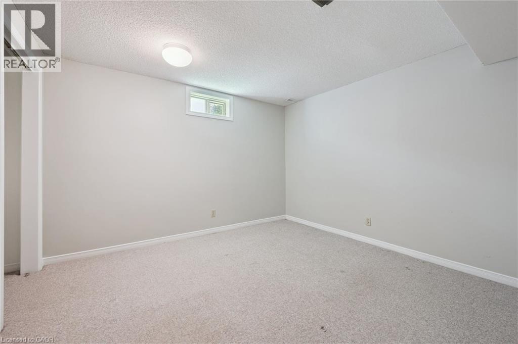 Carpeted flooring, neutral wall color, and a window for natural light - 512 Thorndale Drive, Waterloo, ON