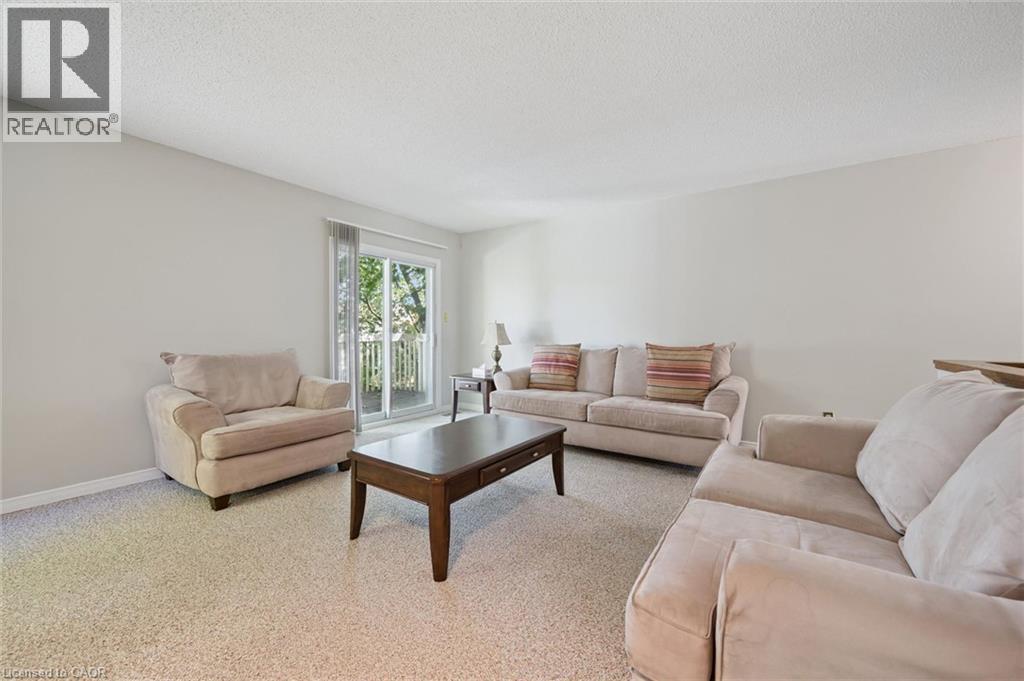 Light-colored walls, textured ceiling, and carpeting throughout - 512 Thorndale Drive, Waterloo, ON