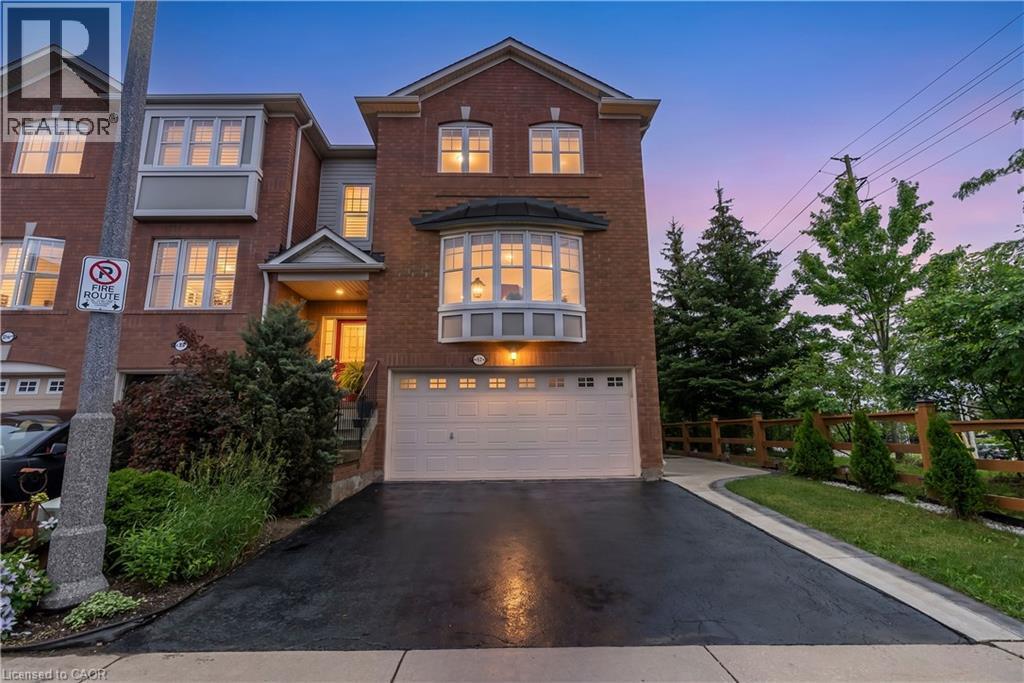 Brick exterior with a prominent bay window and an attached garage - 2435 Coho Way, Oakville, ON