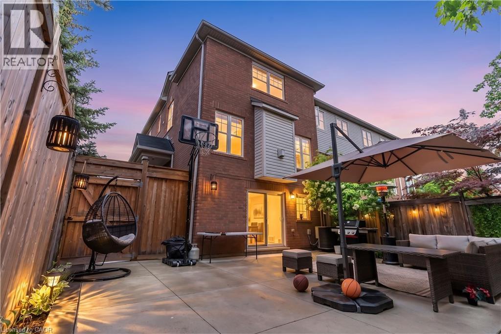Spacious concrete patio with brick exterior and fenced perimeter - 2435 Coho Way, Oakville, ON