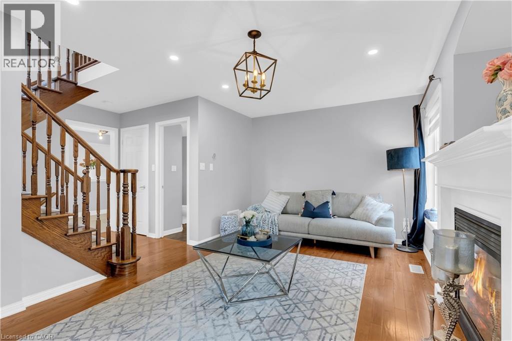 Wood-finish flooring throughout, recessed lighting, and a detailed wood staircase - 2435 Coho Way, Oakville, ON