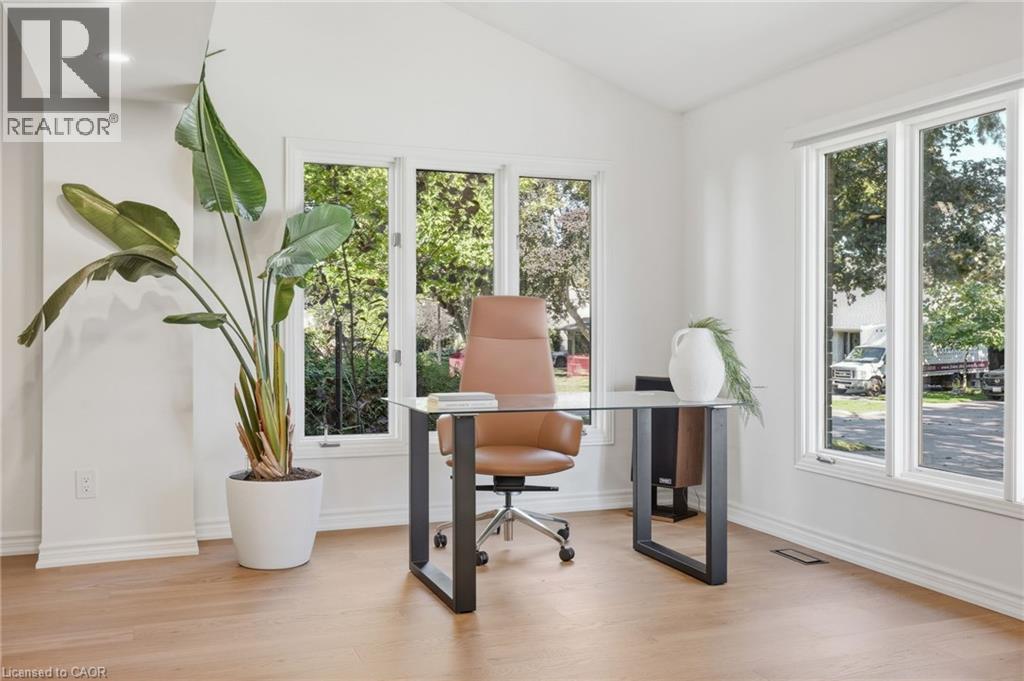 Vaulted ceiling with recessed lighting, wood-finish flooring, and multiple large windows - 4159 Spruce Avenue, Burlington, ON
