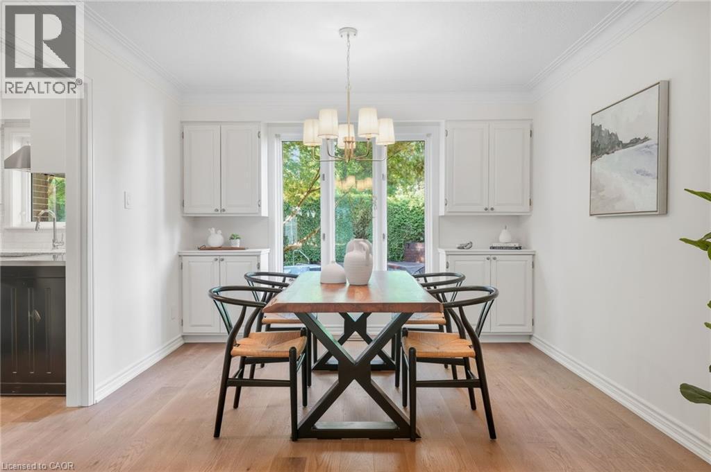 Wood-finish flooring throughout, with white walls and crown molding - 4159 Spruce Avenue, Burlington, ON