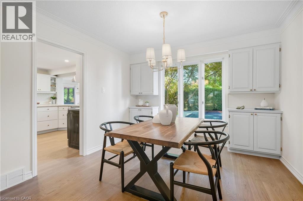 Hardwood-finish flooring, built-in cabinetry, crown molding, and a decorative chandelier - 4159 Spruce Avenue, Burlington, ON