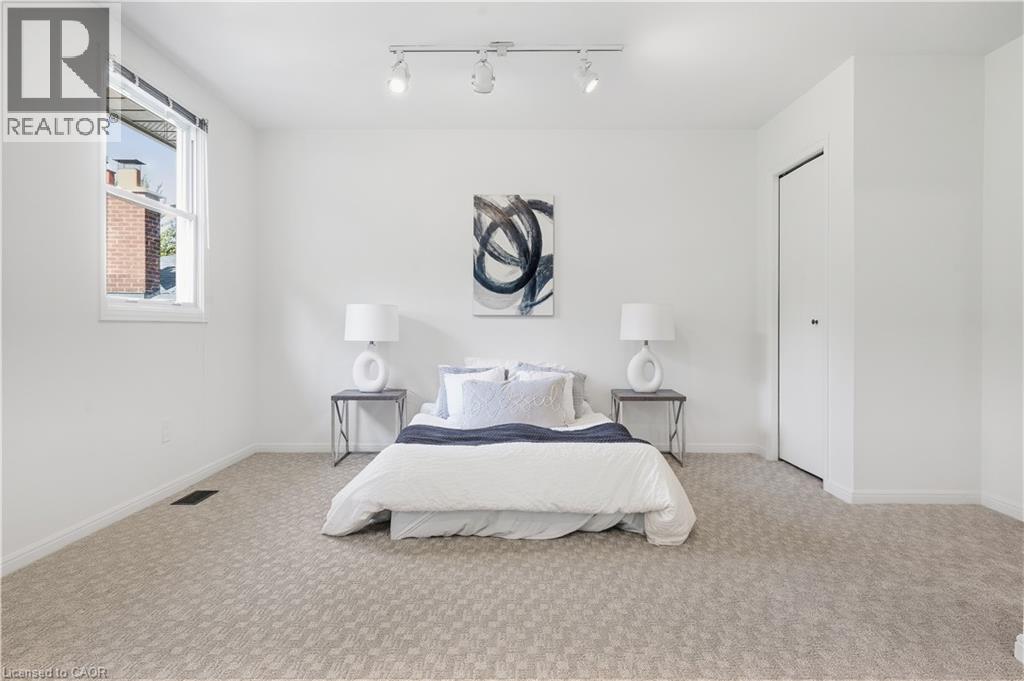 Recessed window with white trim, track lighting, and soft carpet flooring - 4159 Spruce Avenue, Burlington, ON
