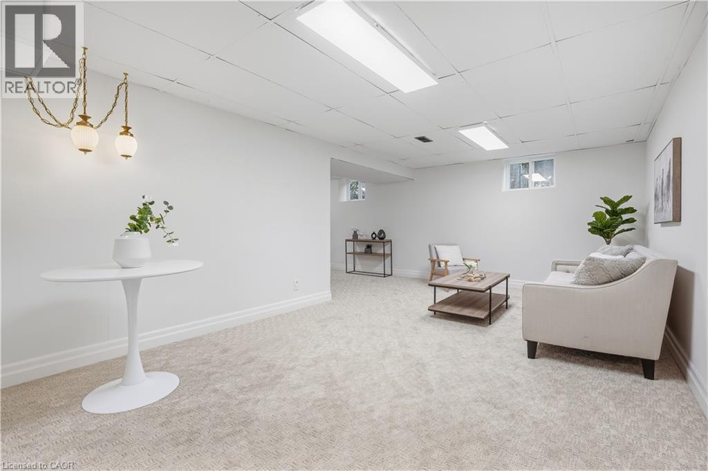 Finished lower level featuring recessed lighting, plush carpeting, and multiple windows providing natural light - 4159 Spruce Avenue, Burlington, ON