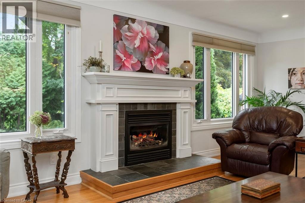 View from family room to in-ground pool in backyard - 200 Woodview Crescent, Ancaster, ON