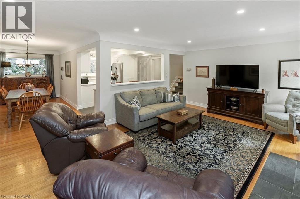 Generous dining room with view to front yard, hardwood flooring and ample space for sideboard - 200 Woodview Crescent, Ancaster, ON