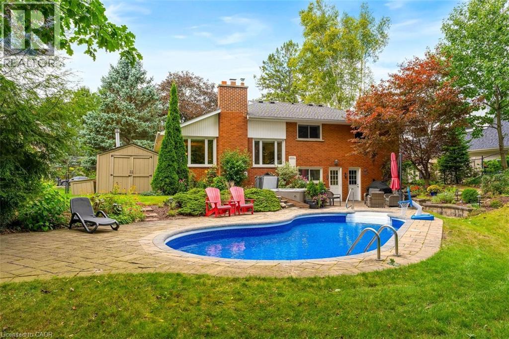 Backyard view highlighting pool, patio and back of home - 200 Woodview Crescent, Ancaster, ON