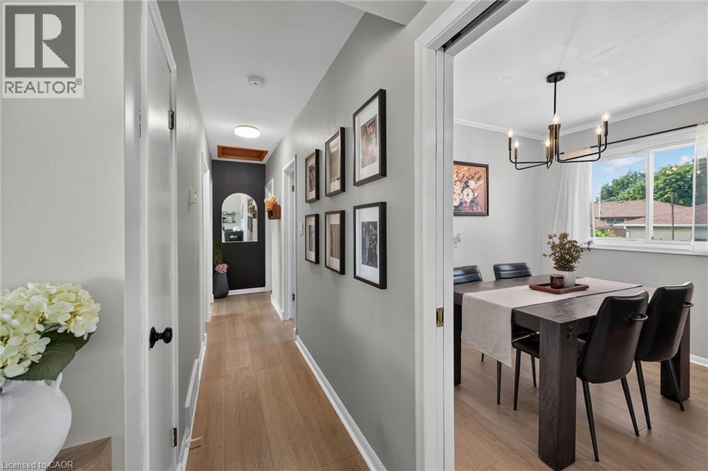 Hallway featuring wood-finish flooring, light gray walls, and recessed lighting - 13 Allanburg Road S, St. Catharines, ON
