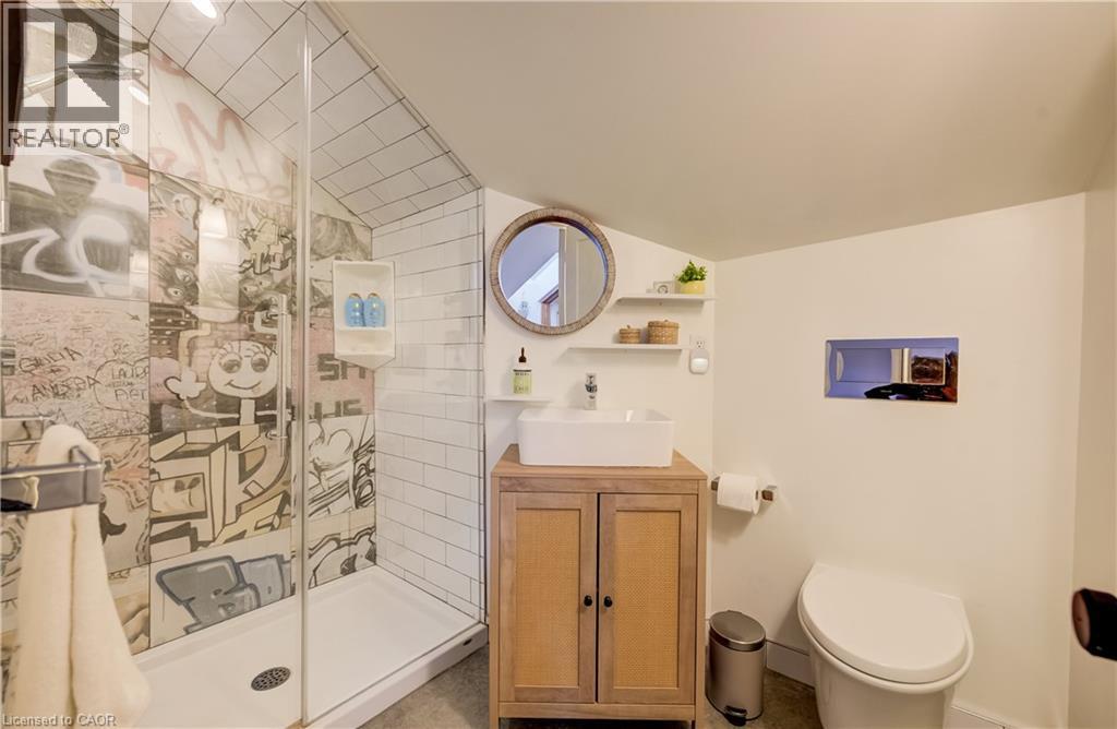 Glass-enclosed shower with subway tile and graphic-patterned wall - 59 Allen Street W, Waterloo, ON