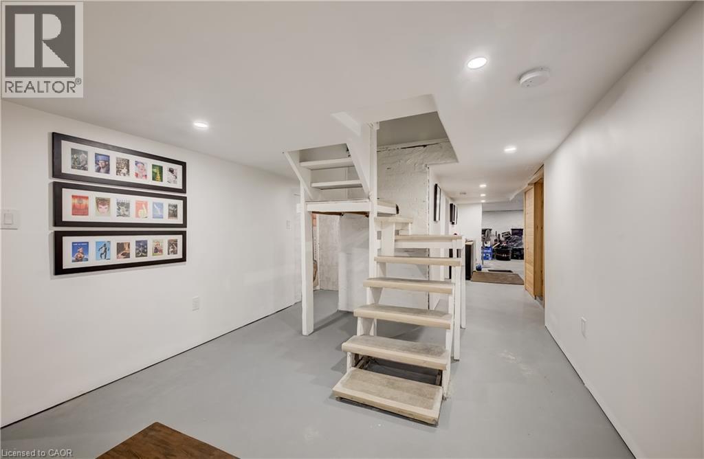 White painted walls, recessed lighting, and gray-painted concrete flooring - 59 Allen Street W, Waterloo, ON