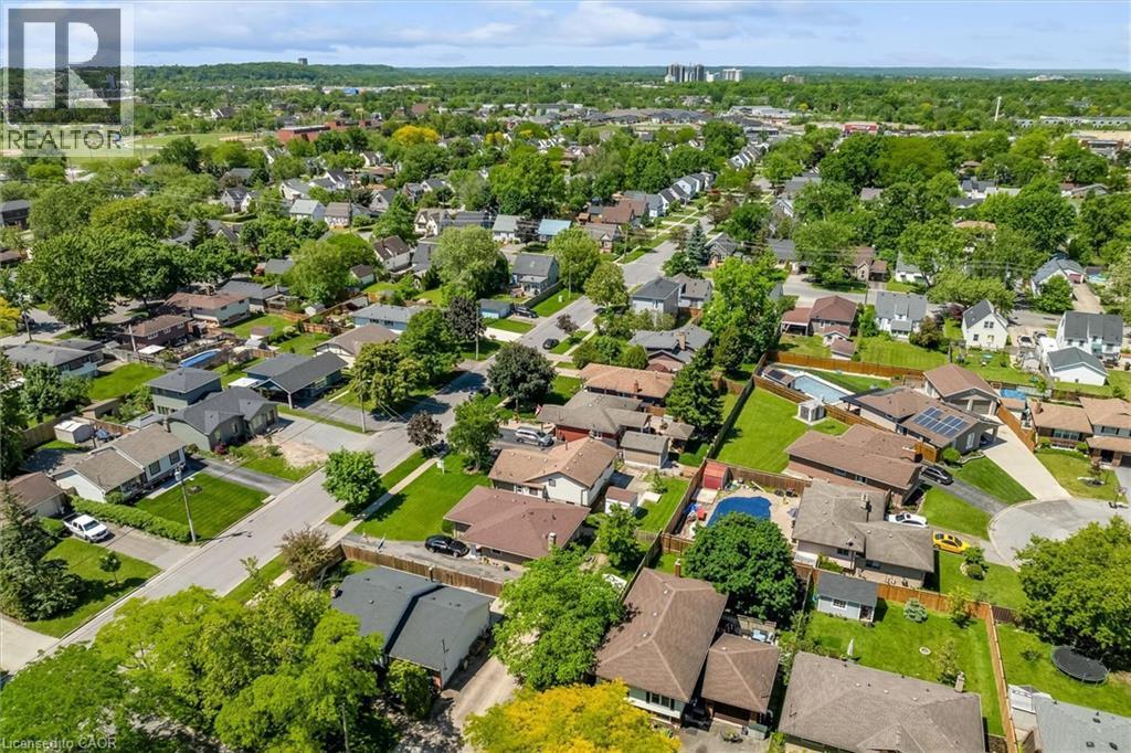 Expansive residential community featuring mature trees, a mix of architectural styles, and private outdoor swimming pools - 49 Grove Avenue, St. Catharines, ON