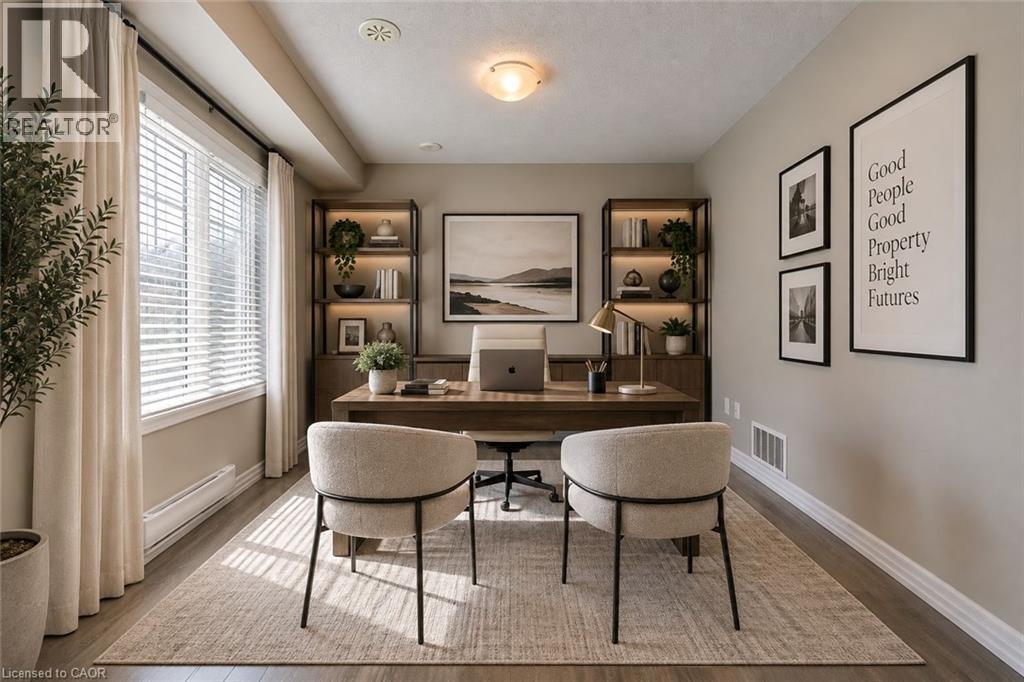Dedicated home office featuring built-in shelving with wood-finish backing, a spacious desk with integrated storage, and two upholstered chairs - 212 Ellen Davidson Drive, Oakville, ON