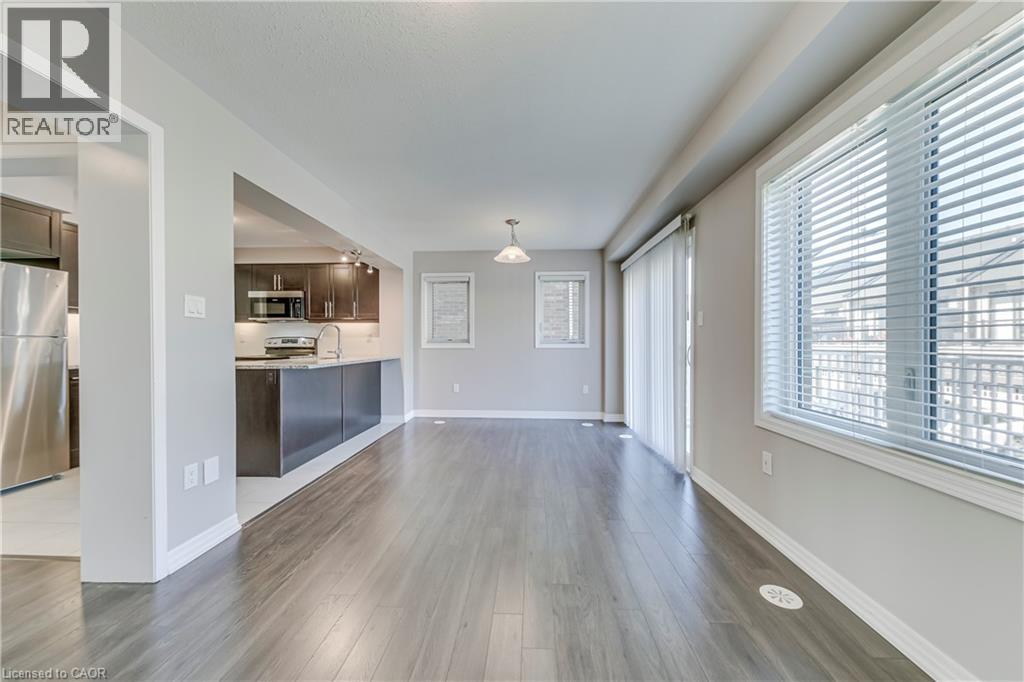 Open concept living area with wood-finish flooring - 212 Ellen Davidson Drive, Oakville, ON