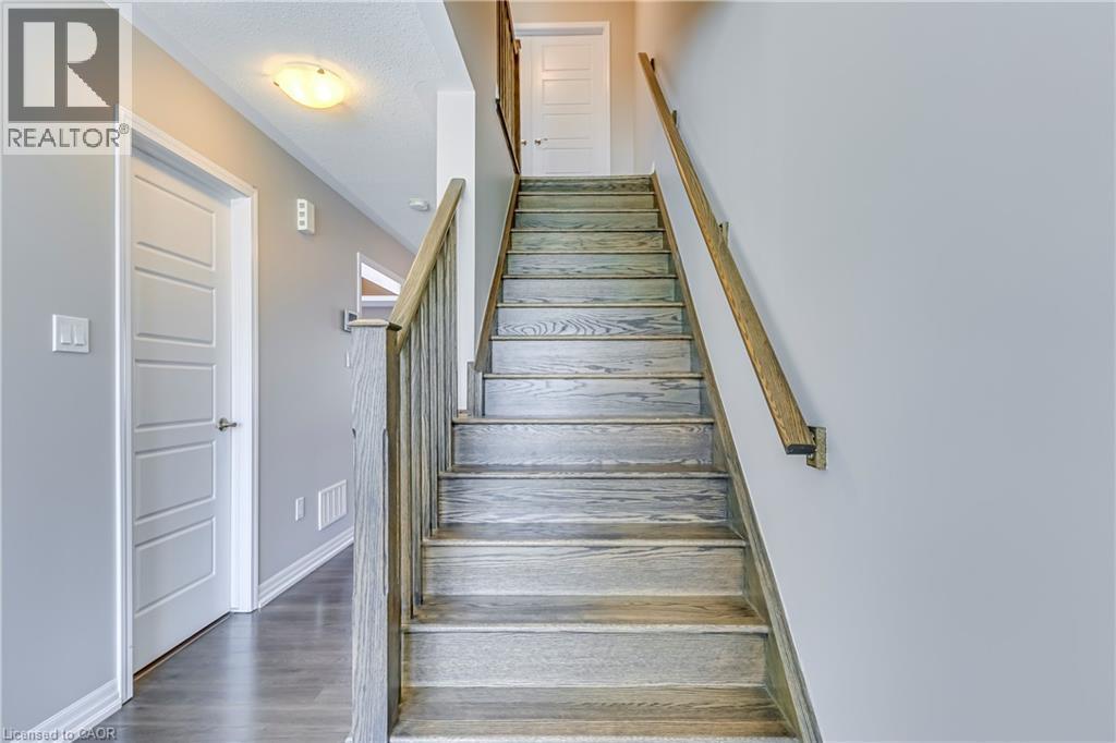 Wood-finish staircase with coordinating wood-finish handrails - 212 Ellen Davidson Drive, Oakville, ON