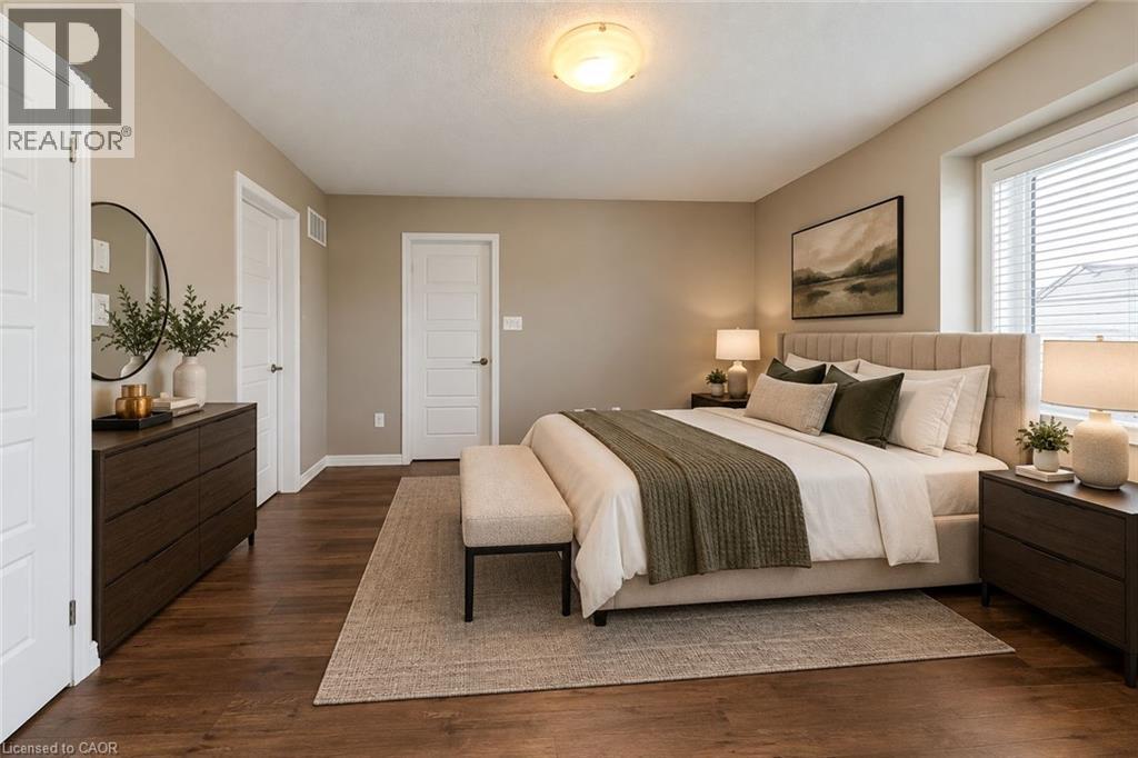 Primary Bedroom Suite featuring hardwood flooring, warm neutral wall finishes, recessed ceiling lighting, and dual nightstands with attached task lighting - 212 Ellen Davidson Drive, Oakville, ON