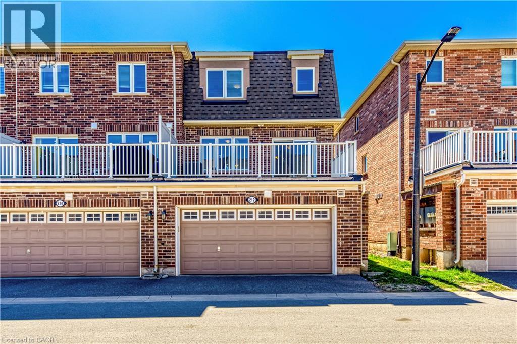 Brick exterior with multiple windows - 212 Ellen Davidson Drive, Oakville, ON