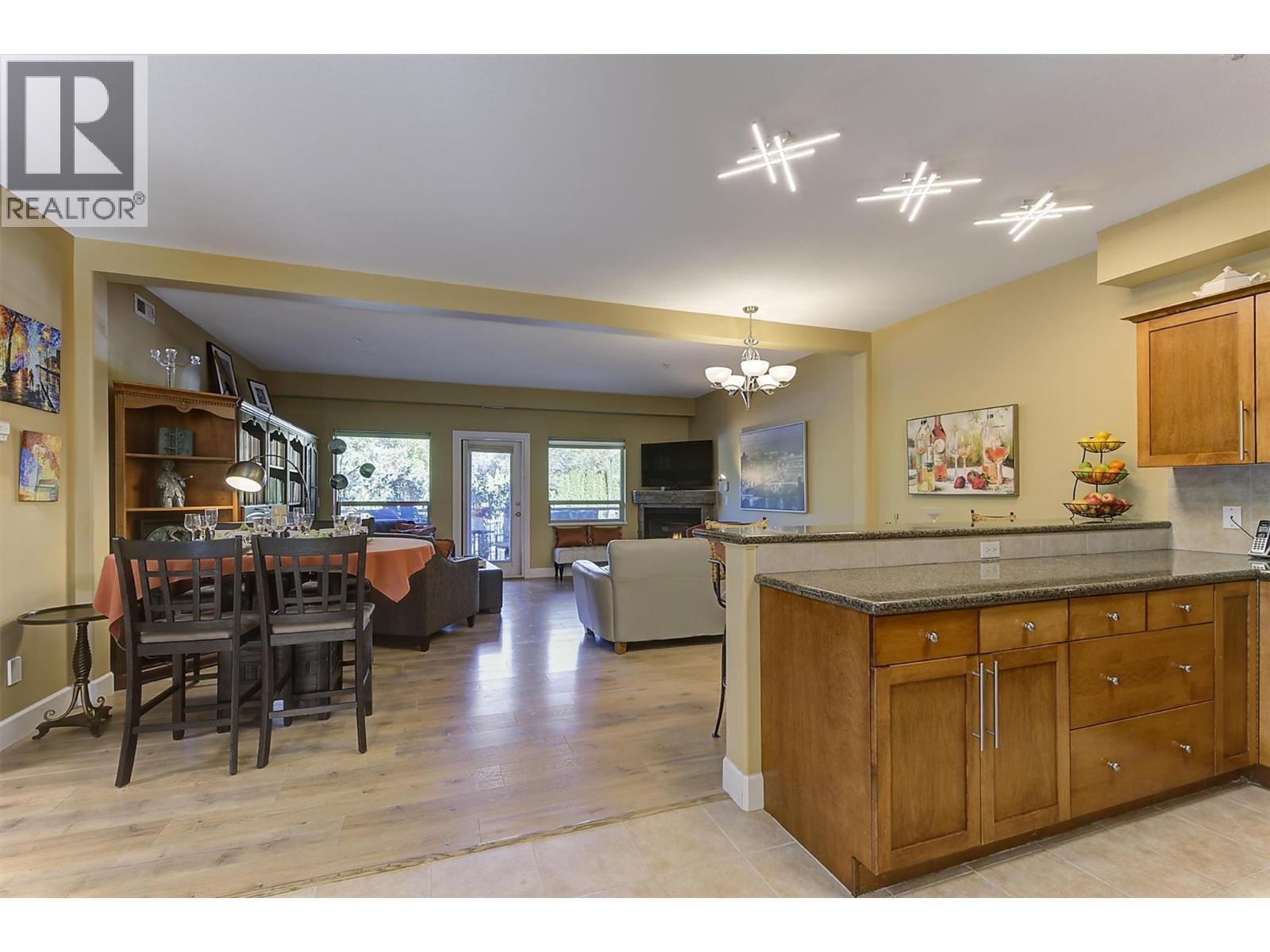 Dining Area Blends Nicely with Living Room and Kitchen. - 3996 Beach Avenue Unit# 236, Peachland, BC