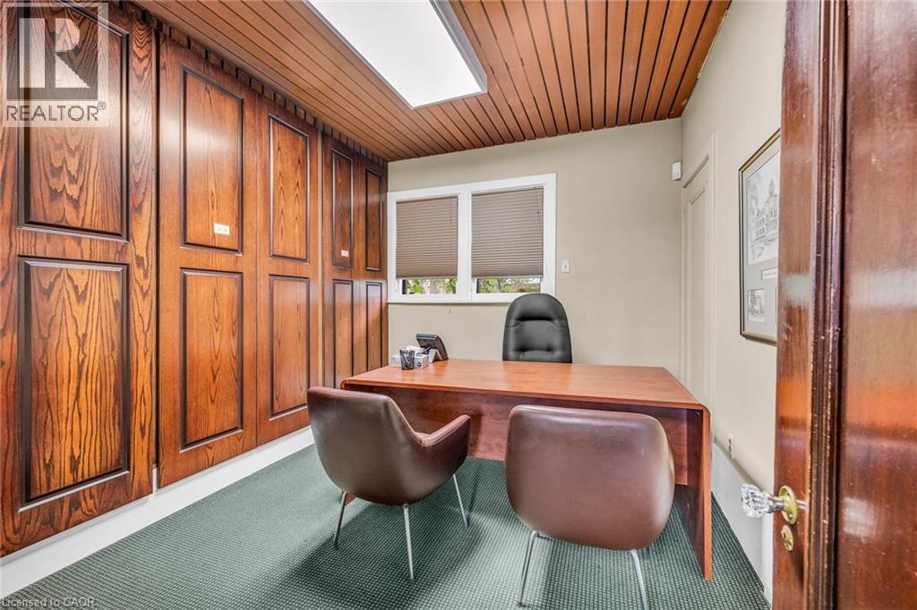 Wood paneling along one wall and ceiling, window with blinds, recessed lighting, and green carpet flooring - 414 Main Street E, Hamilton, ON