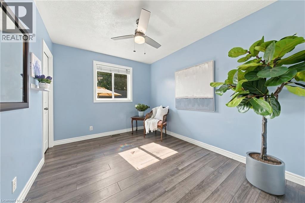 Wood-finish flooring, light blue walls, and a white-trimmed window - 915 St George Street, Port Dover, ON