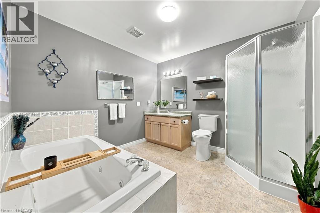 Walk-in shower with frosted glass enclosure, large jetted tub - 915 St George Street, Port Dover, ON