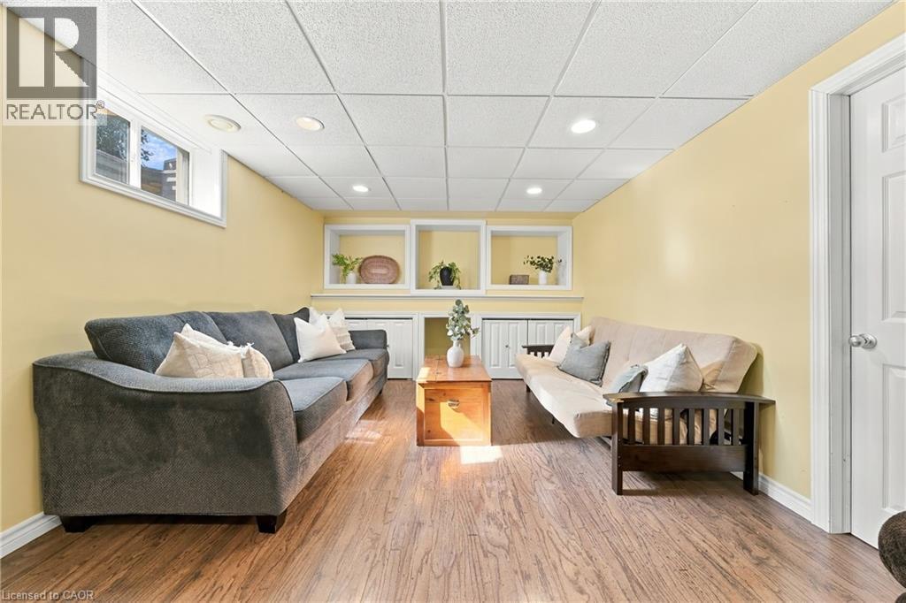 Wood-finish flooring, recessed lighting, drop ceiling, built-in shelving, white paneled door - 915 St George Street, Port Dover, ON