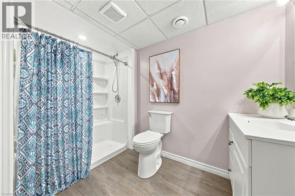 White vanity with double-door cabinetry and a countertop sink - 915 St George Street, Port Dover, ON