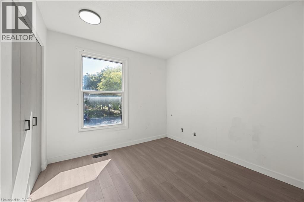 Recessed ceiling light fixture, wood-finish flooring, and single window with light-toned trim - 70 Fiddlers Green Road Unit# 74, London, ON