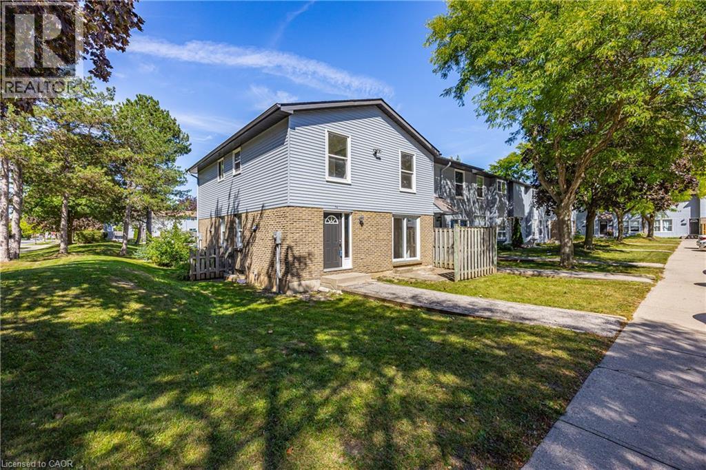 Two-story property featuring light blue siding and a brick-finish lower level - 70 Fiddlers Green Road Unit# 74, London, ON