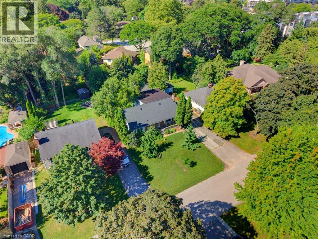 Expansive lot with mature trees, a private driveway, and a lush green lawn - 940 Harvey Place, Halton, ON