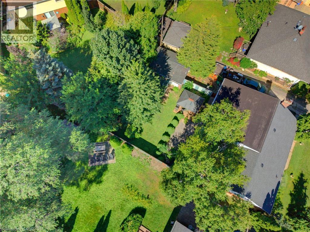 Expansive green space featuring mature trees and a dedicated patio area - 940 Harvey Place, Halton, ON