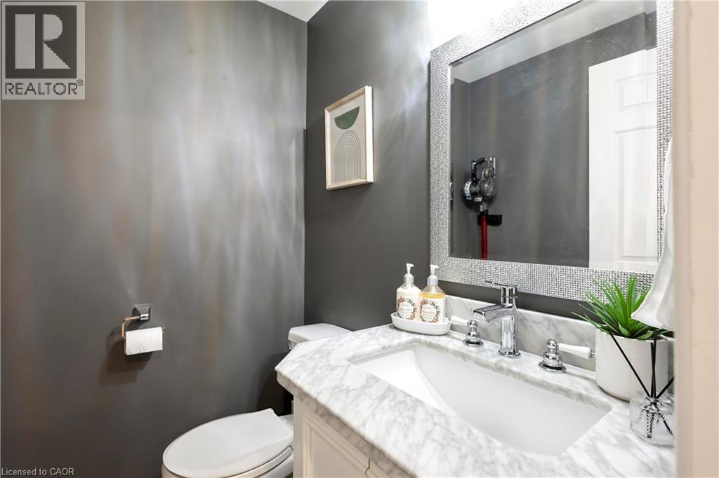 White vanity with a marble countertop, undermount sink, and chrome faucet - 475 Beechwood Drive Unit# 4, Waterloo, ON