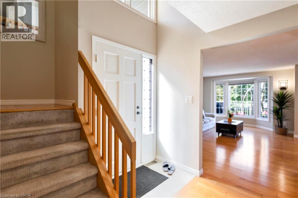 Hardwood flooring, bay window, natural light, carpeted staircase, and wood handrail - 475 Beechwood Drive Unit# 4, Waterloo, ON