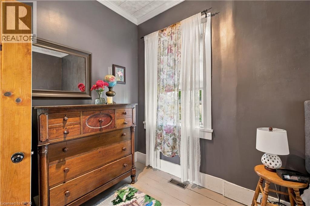 Hardwood flooring with a matte finish, painted wall surfaces, and a window with trim - 2744 Bleams Road, New Hamburg, ON