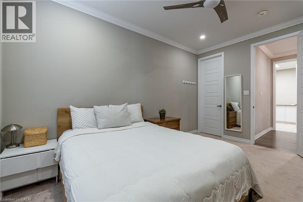 Crown molding accentuates the ceiling, complemented by recessed lighting and a ceiling fan - 455 Equestrian Way, Cambridge, ON
