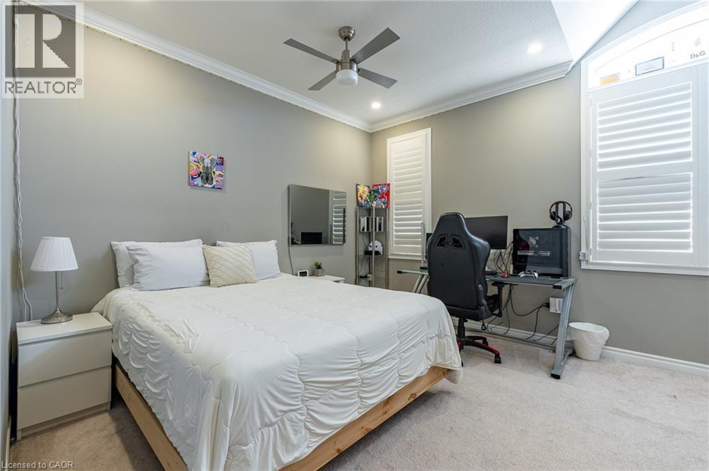 Plush carpeting, crown molding, a ceiling fan with integrated lighting, recessed lighting, and plantation shutters - 455 Equestrian Way, Cambridge, ON