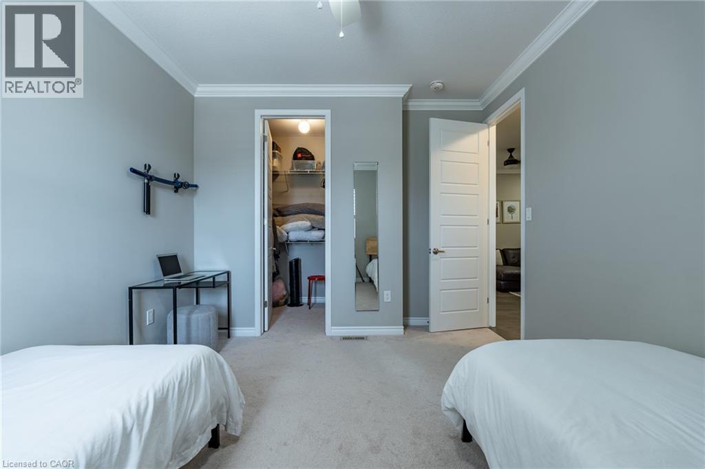 Neutral toned walls, crown molding, paneled interior doors, and carpeted flooring - 455 Equestrian Way, Cambridge, ON