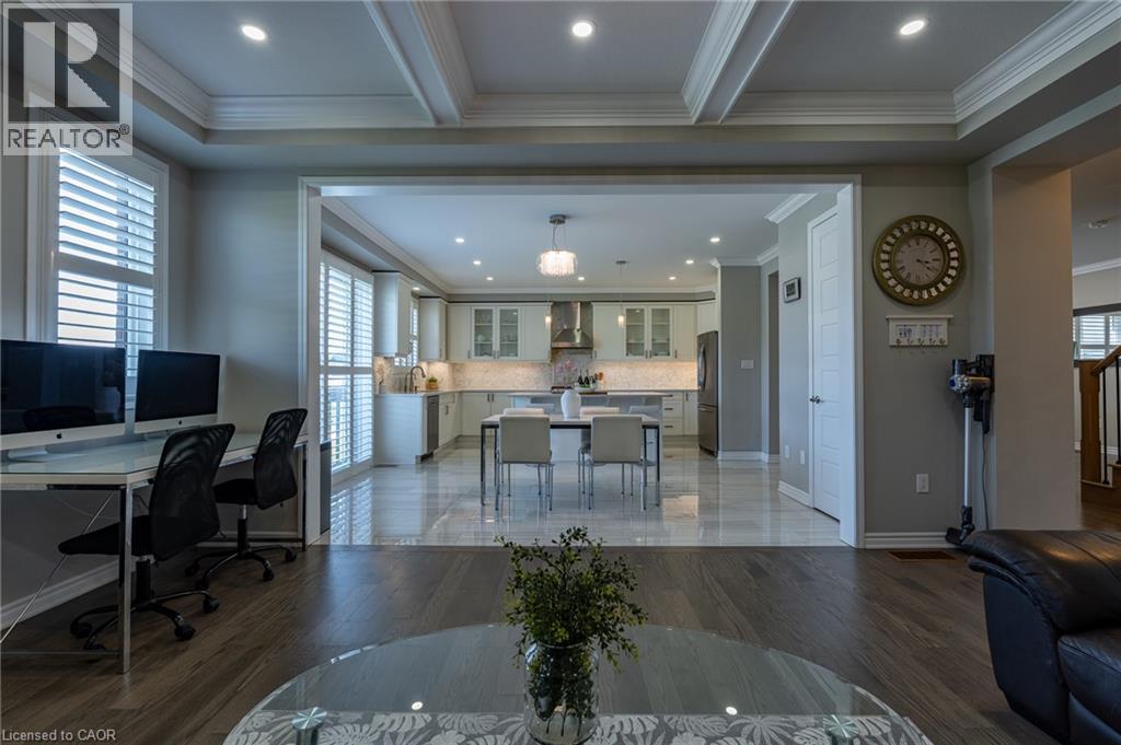 Wood-finish flooring with a coffered ceiling and recessed lighting - 455 Equestrian Way, Cambridge, ON