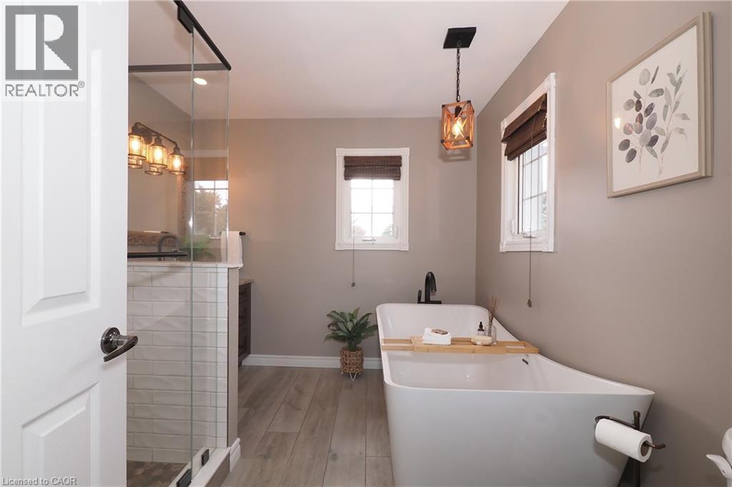 Updated ensuite bathroom with huge soaker tub, two person shower and heated flooring. - 76 Nith River Way, Ayr, ON