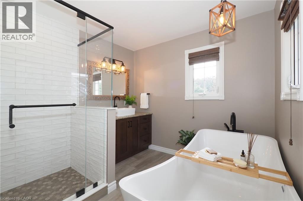 Updated ensuite bathroom with huge soaker tub, two person shower and heated flooring. - 76 Nith River Way, Ayr, ON