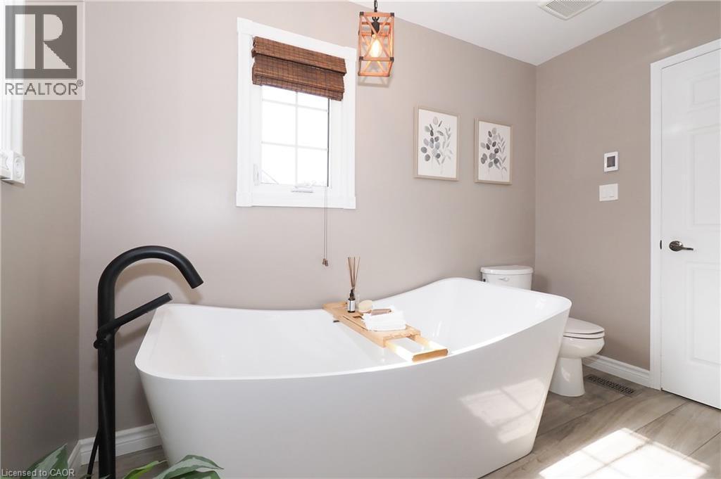 Updated ensuite bathroom with huge soaker tub, two person shower and heated flooring. - 76 Nith River Way, Ayr, ON