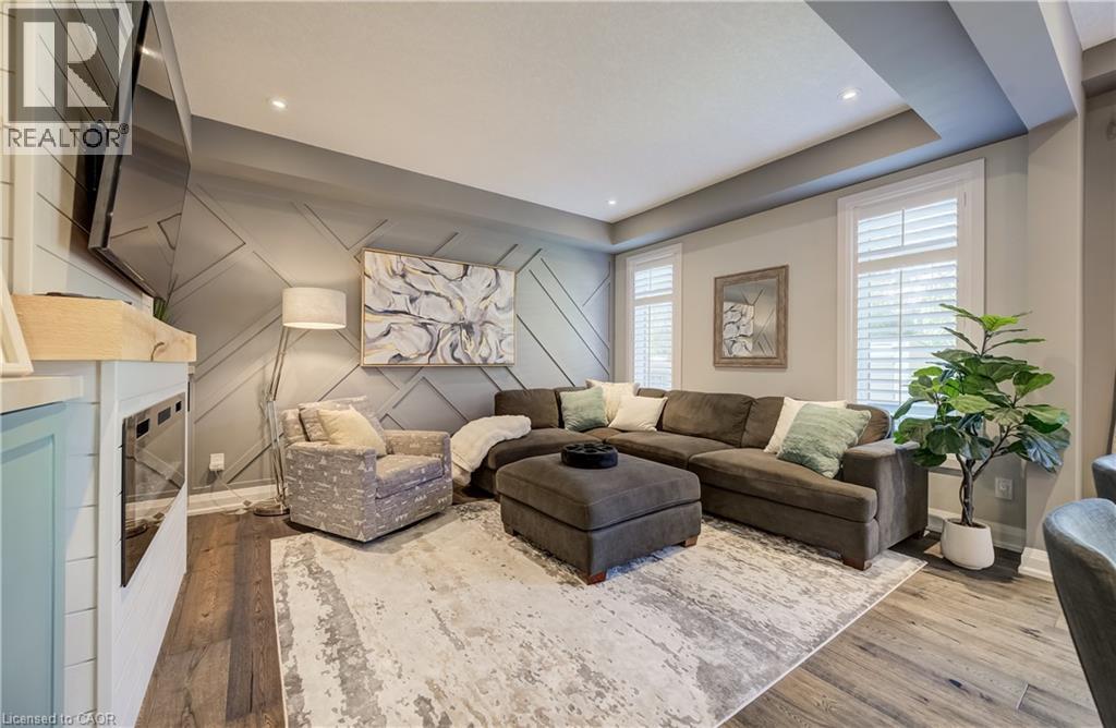 Wood-finish flooring, recessed lighting, and a tray ceiling - 35 Greyhawk Street, Kitchener, ON