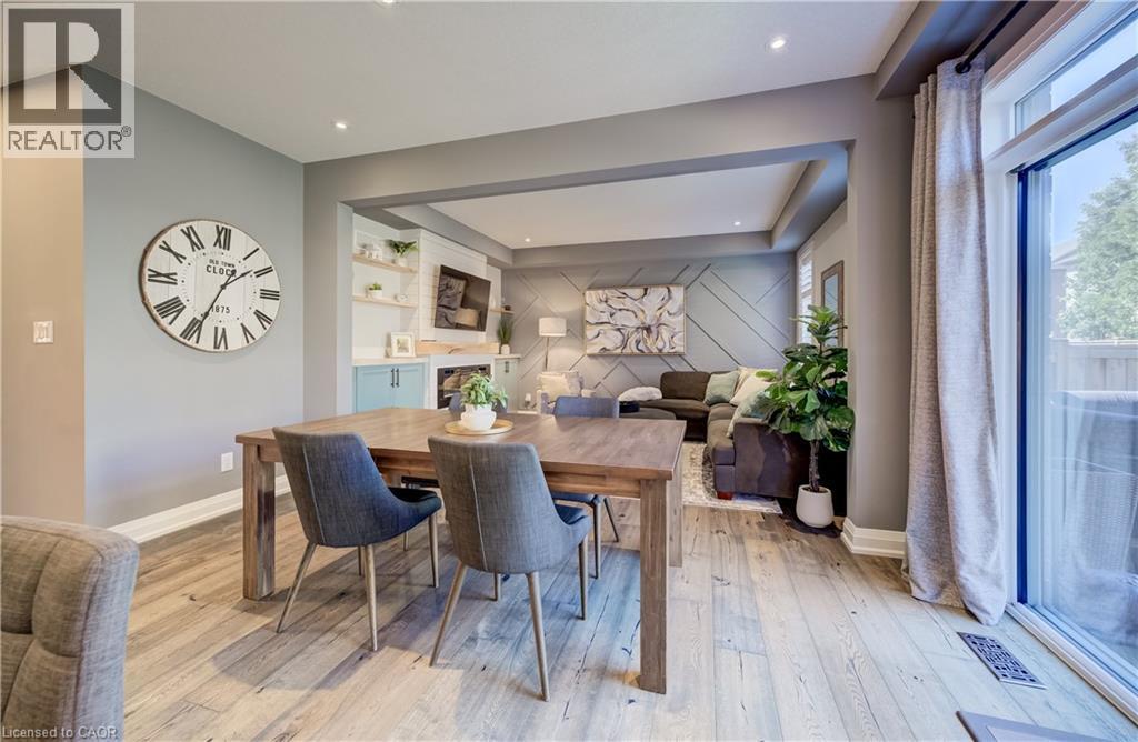 Wood-finish flooring throughout, recessed lighting, and a sliding glass door - 35 Greyhawk Street, Kitchener, ON