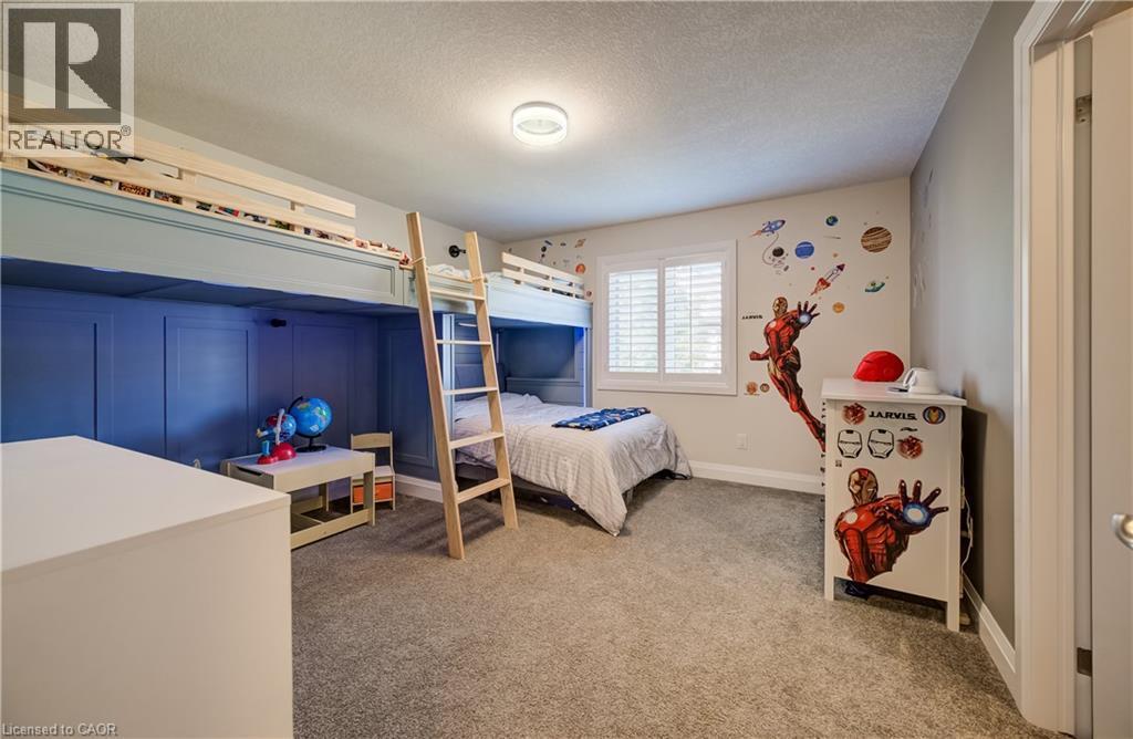 Integrated bunk beds with a natural wood ladder, wall paneling, carpeting, and plantation shutters - 35 Greyhawk Street, Kitchener, ON