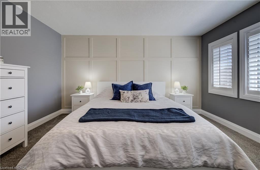 Custom wall paneling, dual windows with plantation shutters, plush carpet flooring, and painted walls - 35 Greyhawk Street, Kitchener, ON