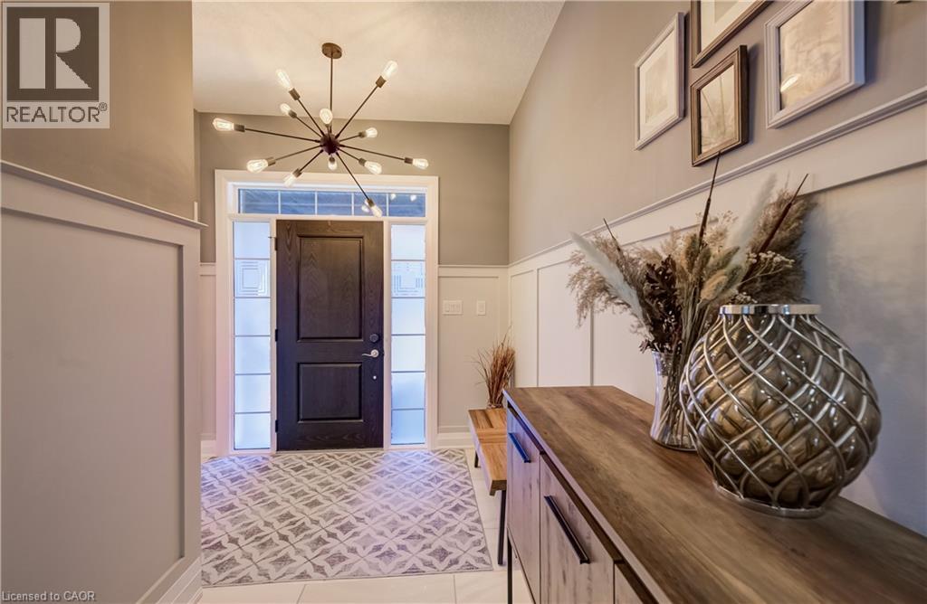 Entry foyer with a dark wood-finish door, transom window, and sidelights - 35 Greyhawk Street, Kitchener, ON