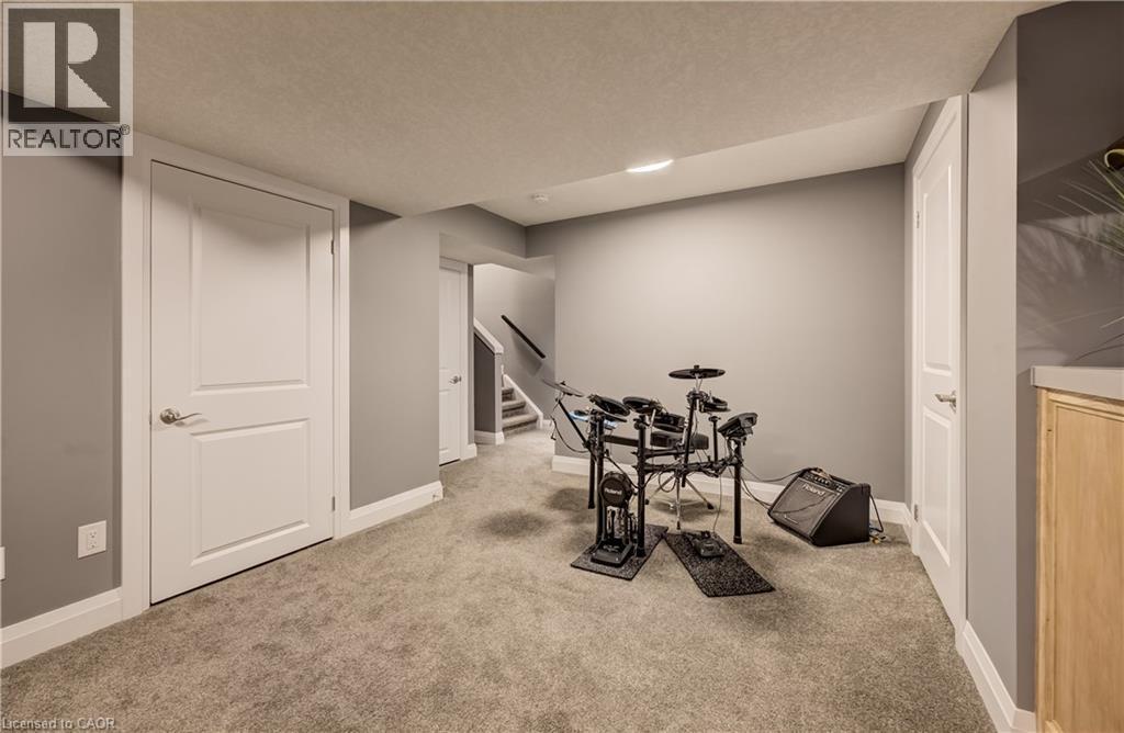 Carpeted lower level featuring recessed lighting, painted walls, and white trim - 35 Greyhawk Street, Kitchener, ON